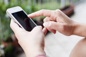 a woman is using her smartphone